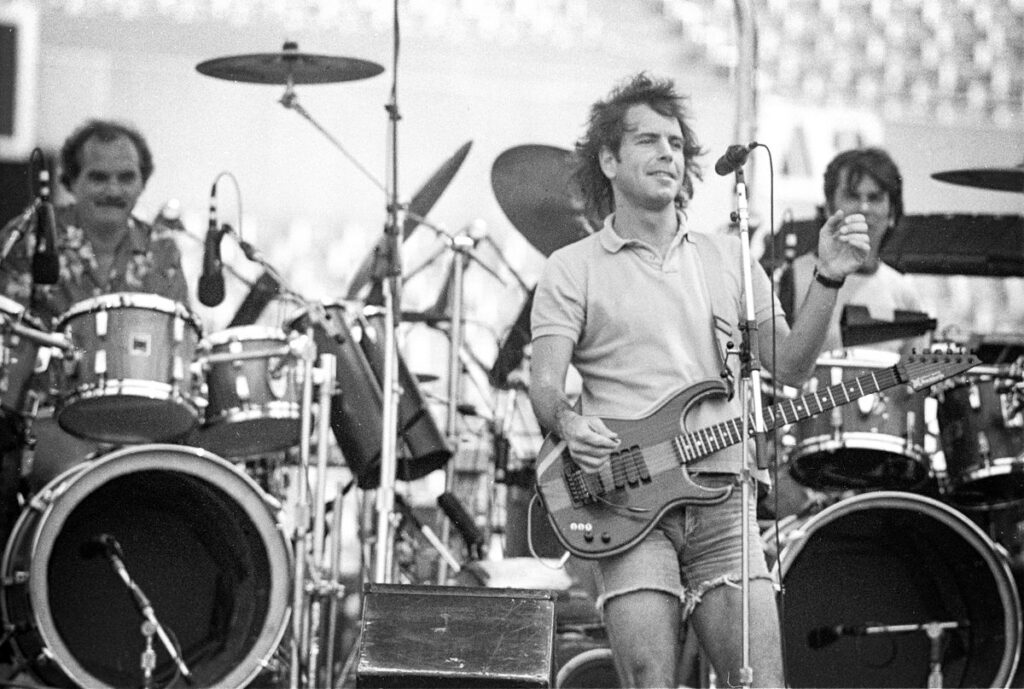 Bob Weir of the Grateful Dead singing and playing guitar at Rich Stadium, Buffalo NY, July 4, 1986 - concert photography by Chuck Spang
