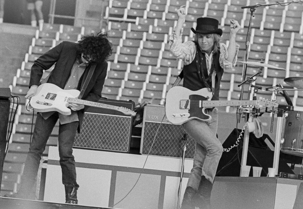 Tom Petty and Mike Campbell of the Heartbreakers performing live, Rich Stadium, Buffalo NY, 1986 True Confessions Tour - concert photography by Chuck Spang