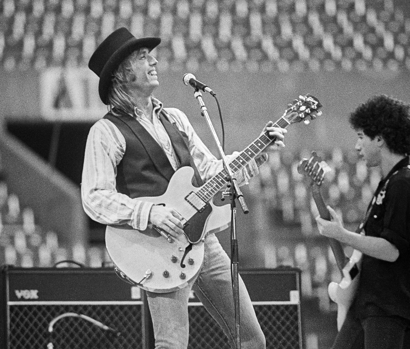 Tom Petty performing live at Rich Stadium, Buffalo NY, 1986 True Confessions Tour with Bob Dylan - concert photography by Chuck Spang