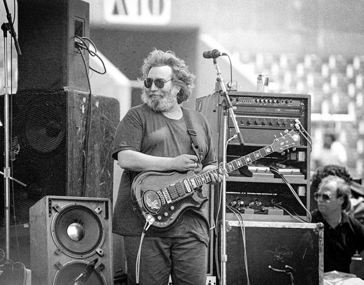 Jerry Garcia performing live at Rich Stadium, Buffalo NY, 1986 True Confessions Tour, playing his custom-built guitar believed to be "Tiger" - concert photography by Chuck Spang