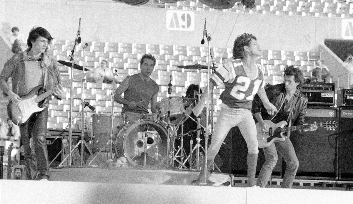 The Rolling Stones - Ronnie Wood, Charlie Watts, Mick Jagger in No. 21 football jersey and Keith Richards - live at Rich Stadium, Buffalo NY, 1981 - concert photography by Chuck Spang