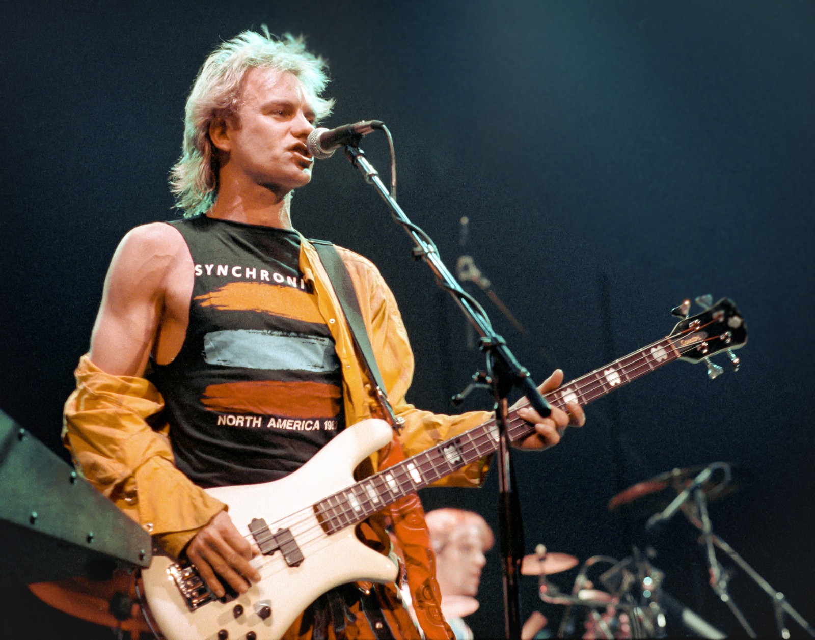 Sting of The Police singing and playing bass live at Buffalo Memorial Auditorium, Buffalo NY, 1984 Synchronicity Tour - concert photography by Chuck Spang